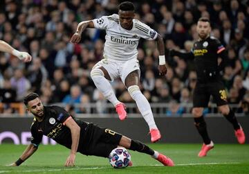 Starring | Real Madrid's Brazilian forward Vinicius Jr skips over Manchester City's Algerian midfielder Riyad Mahrez.