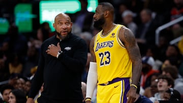 Los Angeles Lakers head coach Darvin Ham (L) talks with Lakers forward LeBron James (23) against the Washington Wizards in the first half at Capital One Arena.