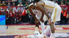 Real Madrid's Fabien Causeur reacts after sustaining an injury as teammates look on.