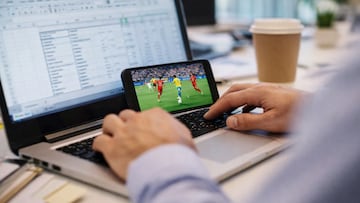 Office worker sneaks a soccer match - artist's impression