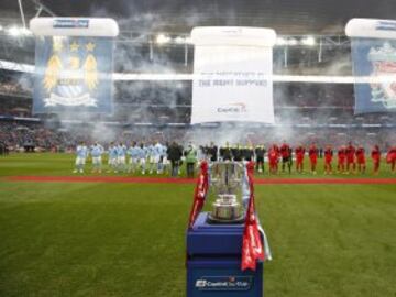 Both teams line up before kick-off, the Capital One trophy on display on the touchline.