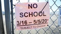 A &quot;No School&quot; sign hangs on a locked gate to Moor Field special education school in Alhambra, California on April 28, 2020 as schools across the state remain closed due to the novel coronavirus pandemic. - California may start the new school yea