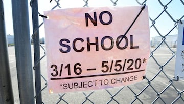 A &quot;No School&quot; sign hangs on a locked gate to Moor Field special education school in Alhambra, California on April 28, 2020 as schools across the state remain closed due to the novel coronavirus pandemic. - California may start the new school yea