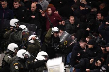 AEK Athens fans jumped onto the pitch and launched flares at the Ajax fans in the Champions League game in Greece on Tuesday night, causing police to intervene.