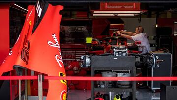 Mechanics work on the car of Ferrari's German driver Sebastian Vettel in the pits at Silverstone motor racing circuit in Silverstone, central England, on July 11, 2019 ahead of the British Formula One Grand Prix. (Photo by ANDREJ ISAKOVIC / AFP)