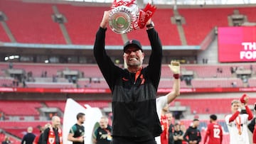 Jürgen Klopp celebrates with the FA Cup trophy after victory over Chelsea at Wembley Stadium.