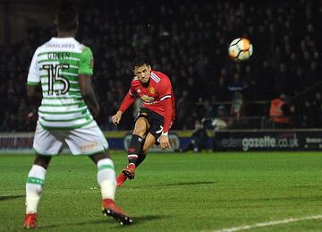 Manchester United's Chilean striker Alexis Sanchez (R) hits a freekick at goal during the FA Cup fourth round football match between Yeovil Town and Manchester United at Huish Park in Yeovil, Somerset on January 26, 2018. / AFP PHOTO / - / RESTRICTED TO EDITORIAL USE. No use with unauthorized audio, video, data, fixture lists, club/league logos or 'live' services. Online in-match use limited to 75 images, no video emulation. No use in betting, games or single club/league/player publications.  / 