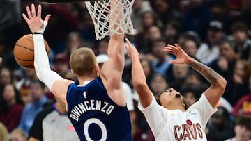 Jan 10, 2026; Cleveland, Ohio, USA; Minnesota Timberwolves guard Donte DiVincenzo (0) knocks the ball away from Cleveland Cavaliers guard Craig Porter Jr. (9) during the first half at Rocket Arena. Mandatory Credit: Ken Blaze-Imagn Images