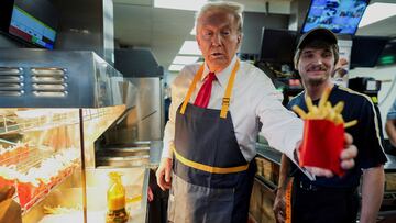 Republican presidential nominee and former U.S. President Donald Trump works behind the counter during a visit to McDonalds in Feasterville-Trevose, Pennsylvania, U.S. October 20, 2024. Doug Mills/Pool via REUTERS