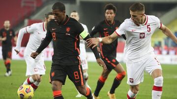 Netherlands' Georginio Wijnaldum, left, and Poland's Jan Bednarek vie for the ball during the Nations League soccer match between Poland and The Netherlands at Silesian Stadium in Chorzow, Poland, Wednesday, Nov. 18, 2020. (AP Photo/Czarek Sokol