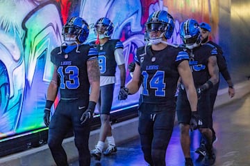 Detroit Lions wide receiver Amon-Ra St. Brown (14) and running back Craig Reynolds (13) walk out to the field for warm ups before the game against the Minnesota Vikings at Ford Field.