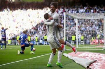 Isco and Lucas Vazquez celebrate.