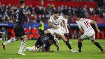 Lille's Jonathan David, second left, vies for the ball with Sevilla's Lucas Ocampos, second right, during the Champions League group G soccer match between Sevilla and Lille at the Ramon Sanchez Pizjuan stadium in Seville, Spain, Tuesday, Nov. 2
