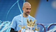 FILE PHOTO: Soccer Football - Premier League - Manchester City v Everton - Etihad Stadium, Manchester, Britain - May 23, 2021 Manchester City manager Pep Guardiola celebrates with the trophy after winning the Premier League Pool via REUTERS/Dave Thompson 