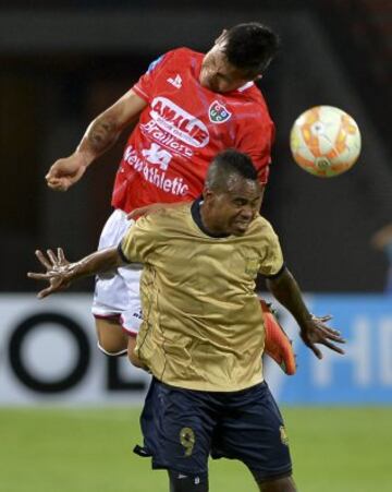 Colombia's Aguilas Doradas player Edinson Palomino (bottom) vies for the ball with Jaime Vasquez of Peru's Union Comercio during their Copa Sudamericana football match at the Atanasio Girardot stadium in Medellin, Antioquia department, Colombia, on August 13, 2015.  AFP PHOTO / RAUL ARBOLEDA