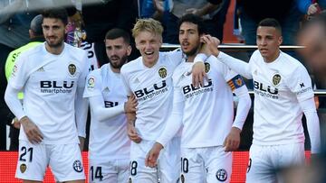 Valencia's Spanish forward Rodrigo Moreno (R) congratulates Valencia's Spanish midfielder Dani Parejo for scoring the opening goal during the Spanish League football match between Valencia CF and SD Huesca at the Mestalla stadium in Valencia on