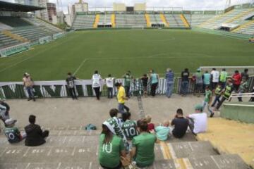 Fans of Brazil's soccer team Chapecoense gather outside the Arena Conda stadium in Chapeco, Brazil, Tuesday, Nov. 29, 2016. A chartered plane that was carrying the Brazilian soccer team to the biggest match of its history crashed into a Colombian hillside and broke into pieces, killing 75 people and leaving six survivors, Colombian officials said Tuesday. (AP Photo/Andre Penner)