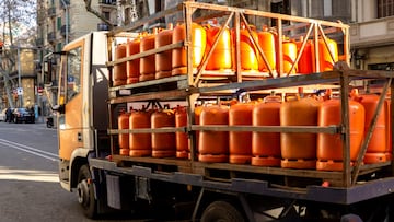 Many orange gas cylinders transported in car