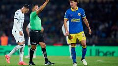 Referee Fernando Guerrero shows yellow card to Igor Lichnovsky of America during the 16th round match between Pumas UNAM and America as part of the Torneo Clausura 2024 Liga BBVA MX at Olimpico Universitario Stadium on April 20, 2024 in Mexico City, Mexico.