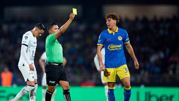Referee Fernando Guerrero shows yellow card to Igor Lichnovsky of America during the 16th round match between Pumas UNAM and America as part of the Torneo Clausura 2024 Liga BBVA MX at Olimpico Universitario Stadium on April 20, 2024 in Mexico City, Mexico.