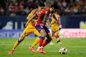 Tigres' Argentine forward #09 Nicolas Ibanez and San Luis' defender #18 Aldo Cruz during the Liga MX Apertura tournament quarter finals first leg football match between San Luis and Tigres at the Alfonso Lastras Stadium in San Luis Potosi, San Luis Potosi State, Mexico, on November 28, 2024. (Photo by MARIO ARMAS / AFP)