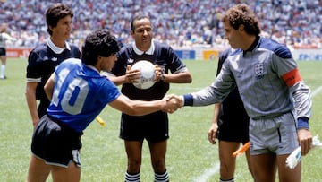 Argentina captain Diego Maradona (l) shakes hands with England captain Peter Shilton (r) as referee Ali Bennaceur (c) checks the match ball is fully inflated and linesman Morera Berny Ulloa (far l) looks on  (Photo by Peter Robinson/EMPICS via Getty Image