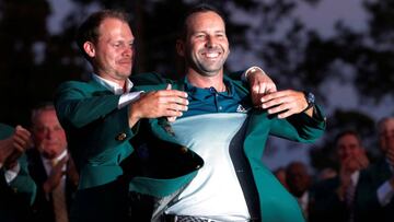 Sergio Garcia of Spain smiles as he is presented the green jacket by last year's champion, Danny Willett of England, after Garcia won the 2017 Masters golf tournament in a playoff at Augusta National Golf Club in Augusta, Georgia, U.S., April 9, 2017. REUTERS/Mike Segar TPX IMAGES OF THE DAY