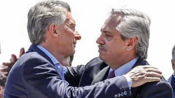 Picture released by Noticias Argentinas showing Argentine outgoing president Mauricio Macri (L) and President-elect Alberto Fernandez embracing during a mass for unity and peace held at the Minor Basilica of Our Lady of Lujan in Lujan, Buenos Aires, on the Feast of the Immaculate Conception on December 8, 2019. - Macri will hand power over to Fernandez on December 10. (Photo by STR / NOTICIAS ARGENTINAS / AFP) / - Argentina OUT / RESTRICTED TO EDITORIAL USE - MANDATORY CREDIT &quot;AFP PHOTO / NA&quot; - NO MARKETING - NO ADVERTISING CAMPAIGNS