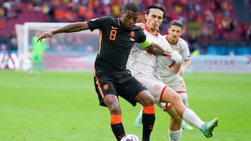 AMSTERDAM, NETHERLANDS - JUNE 21: Georginio Wijnaldum of Netherlands holds off Eljif Elmas of North Macedonia during the UEFA Euro 2020 Championship Group C match between North Macedonia and The Netherlands at Johan Cruijff Arena on June 21, 2021 in Amste