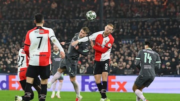 Feyenoord's Polish midfielder #07 Jakub Moder (L) and Feyenoord's Dutch defender #03 Thomas Beelen jump for the ball during the UEFA Champions League knockout phase play-off 1st leg football match between Feyenoord Rotterdam and AC Milan at the Stadion Feijenoord "De Kuip" in Rotterdam, on February 12, 2025. (Photo by JOHN THYS / AFP)