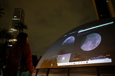 La gente se reúne en el techo del planetario distrital para ver un eclipse lunar en Bogotá, Colombia.