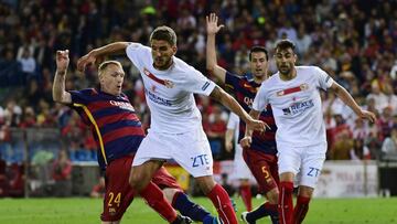 Barcelona's French defender Jeremy Mathieu (L) vies with Sevilla's Portuguese midfielder Daniel Carrico (2nd L) during the Spanish "Copa del Rey" (King's Cup) final match FC Barcelona vs Sevilla FC at the Vicente Calderon stadium in Madrid on May 22, 2016. / AFP PHOTO / PIERRE-PHILIPPE MARCOU