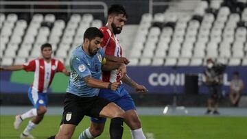 Uruguay's Luis Suarez, left, and Paraguay's Omar Alderete battle for the ball during a Copa America soccer match at Nilton Santos stadium in Rio de Janeiro, Brazil, Monday, June 28, 2021. (AP Photo/Ricardo Mazalan)