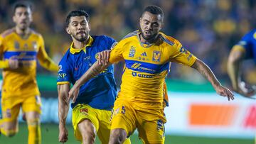 Tigres' Brazilian midfielder Rafael Carioca (R) vies for the ball with America's forward Henry Martin (L) during the Mexican Apertura 2023 match between Tigres and America at the Estadio Universitario in Monterrey, Mexico, December 14, 2023. (Photo by Julio Cesar AGUILAR / AFP)