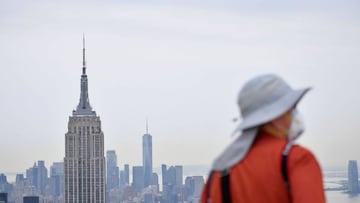 A photographer stands on the Top of The Rock observation deck as it reopens to the public on August 6, 2020 in New York City. - The Top of the Rock was forced to temporarily close in March to help limit the spread of COVID-19. However, the Observation Dec