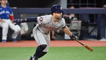 Jul 2, 2024; Toronto, Ontario, CAN;  Houston Astros second baseman Jose Altuve (27) hits a single against the Toronto Blue Jays in the seventh inning at Rogers Centre. Mandatory Credit: Dan Hamilton-USA TODAY Sports