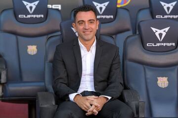 Newly-appointed FC Barcelona's Spanish coach Xavi Hernandez poses for pictures during his presentation ceremony at the Camp Nou stadium in Barcelona on November 8, 2021. (Photo by LLUIS GENE / AFP)