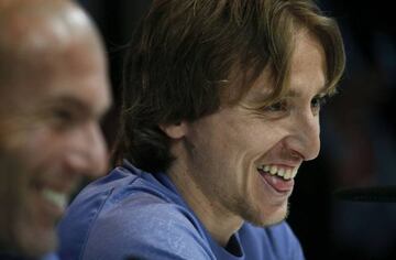 Real Madrid's Luka Modric (R) and coach Zinedine Zidane smile.