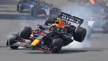 Red Bull Racing's Mexican driver Sergio Perez (R) crashes with Ferrari's Monegasque driver Charles Leclerc  at the start of the Formula One Mexico Grand Prix at the Hermanos Rodriguez racetrack in Mexico City on October 29, 2023. (Photo by CLAUDIO CRUZ / AFP)