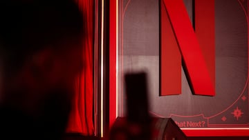 A man takes a photograph next to a Netflix logo during an event in Mumbai, India, February 3, 2026. REUTERS/Francis Mascarenhas