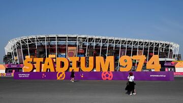 Tourists stand in front the Stadium 974 in Doha on November 19, 2022, ahead of the Qatar 2022 World Cup football tournament. (Photo by MIGUEL MEDINA / AFP)