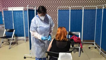A medical worker vaccinates a patient with a dose of the Moderna Covid-19 vaccine, in the rooms of the Claudia Comte exhibition at the Museum of Contemporary Art "Castello di Rivoli" near Turin on May 27, 2021. - The Castle of Rivoli, in collaboration with the city of Rivoli and the local health authority, has defined a pilot project to use the museum as a venue for vaccinations in support of the National Plan for Vaccination Covid-19 in synergy with Cultura Italiae, which had proposed the reopening of the places of culture as new principals to protect the health of citizens. (Photo by Marco BERTORELLO / AFP)