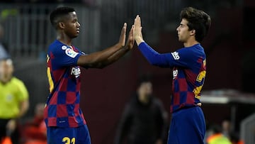 Barcelona's Spanish midfielder Riqui Puig (R) replaces Barcelona's Guinea-Bissau forward Ansu Fati (L) during the Spanish league football match between FC Barcelona and Levante UD at the Camp Nou stadium in Barcelona, on February 2, 2020. (Photo