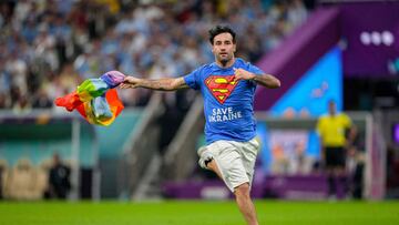 LUSAIL CITY, QATAR - NOVEMBER 28: A protester with Safe Ukraine lettering and rainbow flag on the pitch during the FIFA World Cup Qatar 2022 Group H match between Portugal and Uruguay at Lusail Stadium on November 28, 2022 in Lusail City, Qatar. (Photo by Ulrik Pedersen/DeFodi Images via Getty Images)