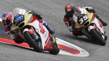 Idemitsu Honda Team Asia's Japanese rider Ai Ogura (L) and Idemitsu Honda Team Asia's Thailand rider Somkiat Chantra compete in the Moto2 Austrian Grand Prix race at the Redbull Ring racetrack in Spielberg on August 21, 2022. (Photo by VLADIMIR SIMICEK / AFP) (Photo by VLADIMIR SIMICEK/AFP via Getty Images)