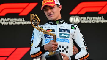 McLaren's British driver Lando Norris looks at the trophy on the podium after winning the Formula One Monaco Grand Prix at the Circuit de Monaco, on May 25, 2025. (Photo by Andrej ISAKOVIC / AFP)