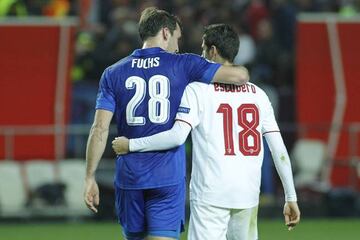 Escudero walks off arm in arm with Leicester's Fuchs after the Champions League match.