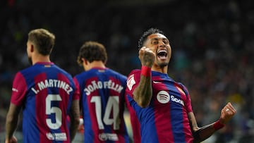 Barcelona's Brazilian forward #11 Raphinha celebrates after scoring his team's first goal during the Spanish league football match between FC Barcelona and UD Las Palmas at the Estadi Olimpic Lluis Companys in Barcelona on March 30, 2024. (Photo by Pau Barrena / AFP)