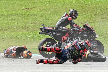 Monster Energy Yamaha MotoGP's French rider Fabio Quartararo (R) and Red Bull KTM Factory's Australian rider Jack Miller (L) fall after a collision during the MotoGP Malaysian Grand Prix at the Sepang International Circuit in Sepang on November 3, 2024. (Photo by MOHD RASFAN / AFP)