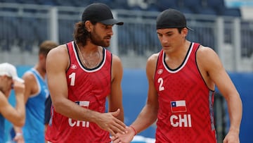 TOKYO, JAPAN - AUGUST 02: Marco Grimalt #1 of Team Chile and Esteban Grimalt #2 react after the play against Team ROC during the Men's Round of 16 beach volleyball on day ten of the Tokyo 2020 Olympic Games at Shiokaze Park on August 02, 2021 in Tokyo, Japan. (Photo by Sean M. Haffey/Getty Images)